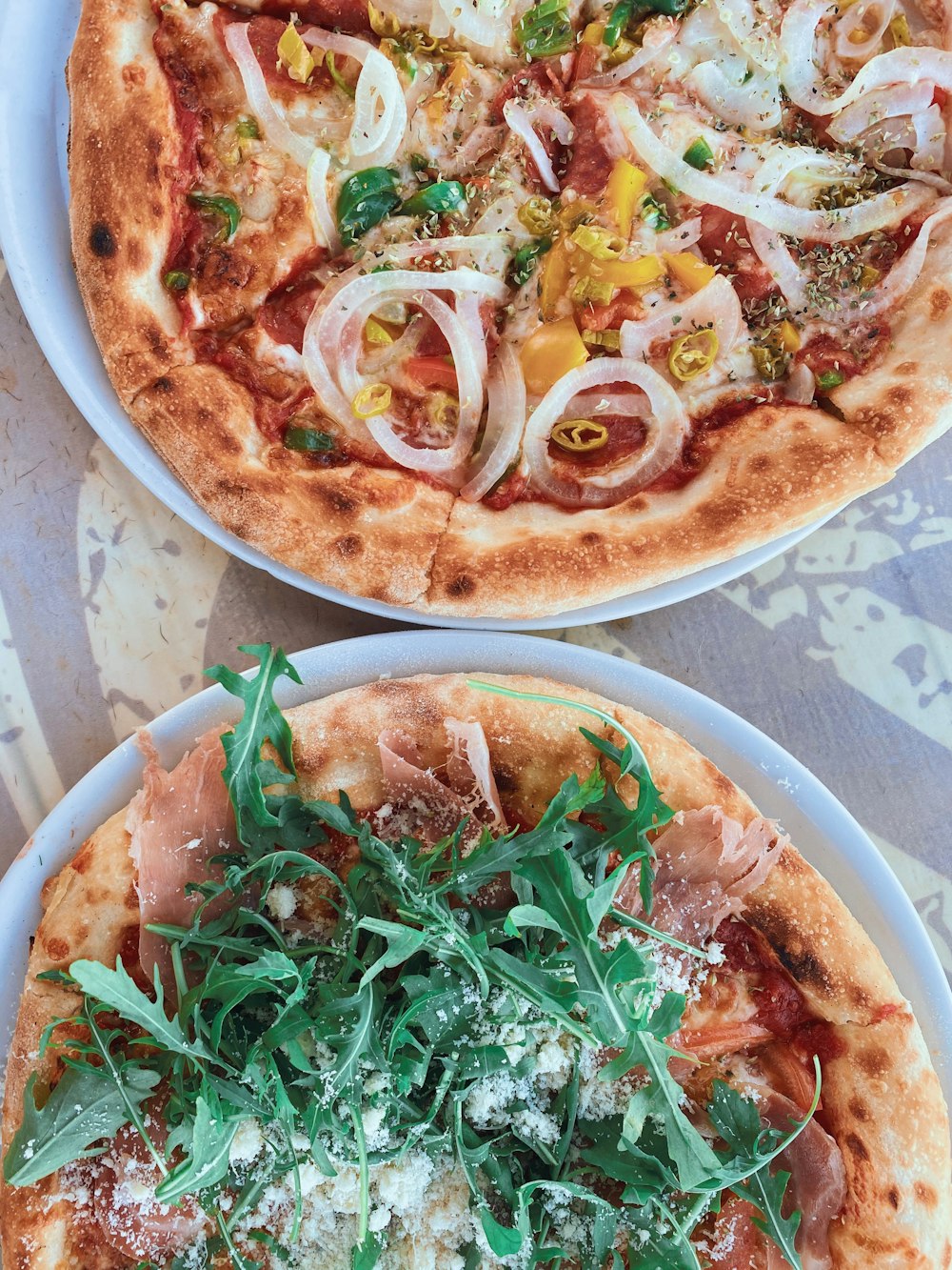 pizza with green leaves on white ceramic plate