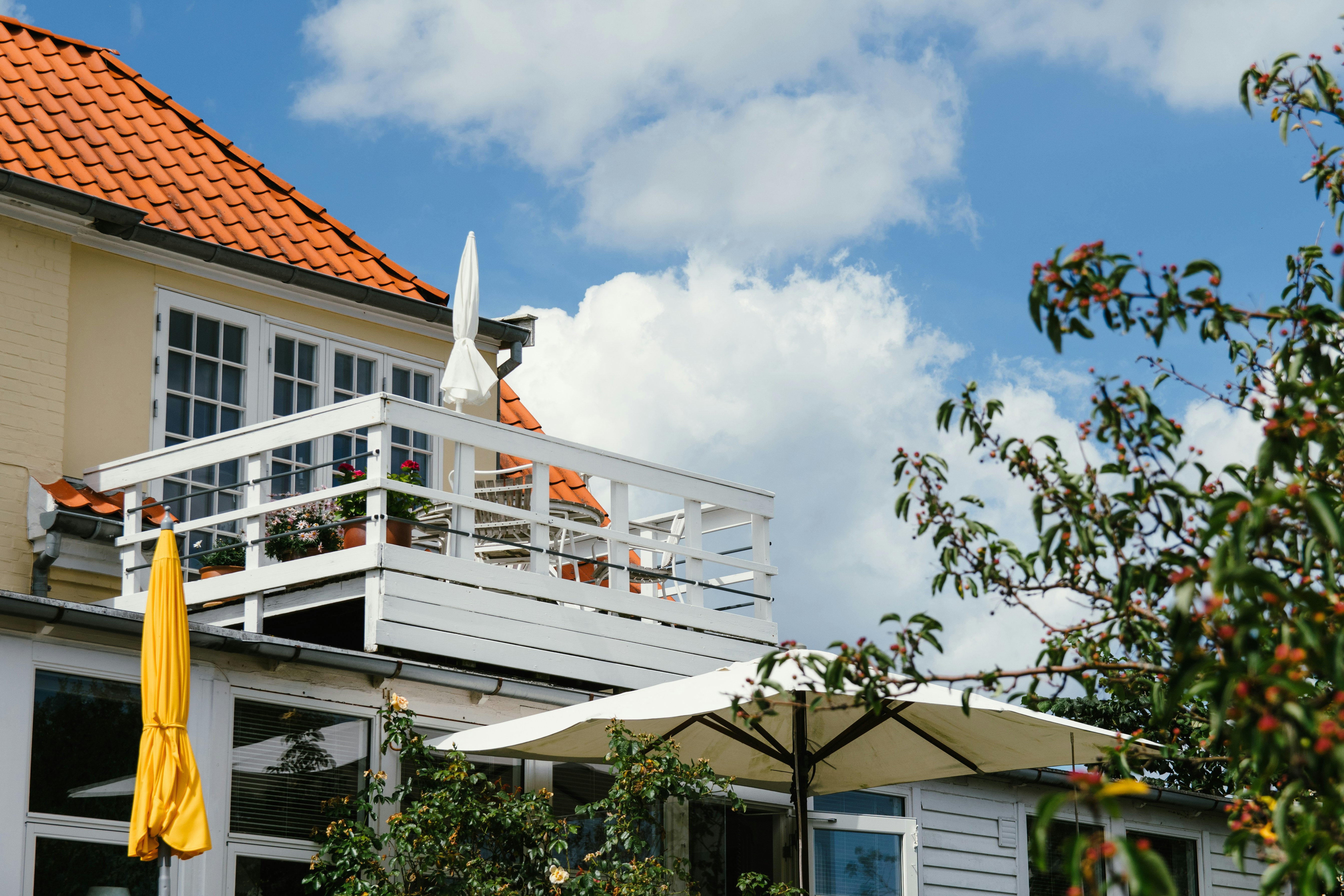White and brown concrete building under white clouds during daytime
