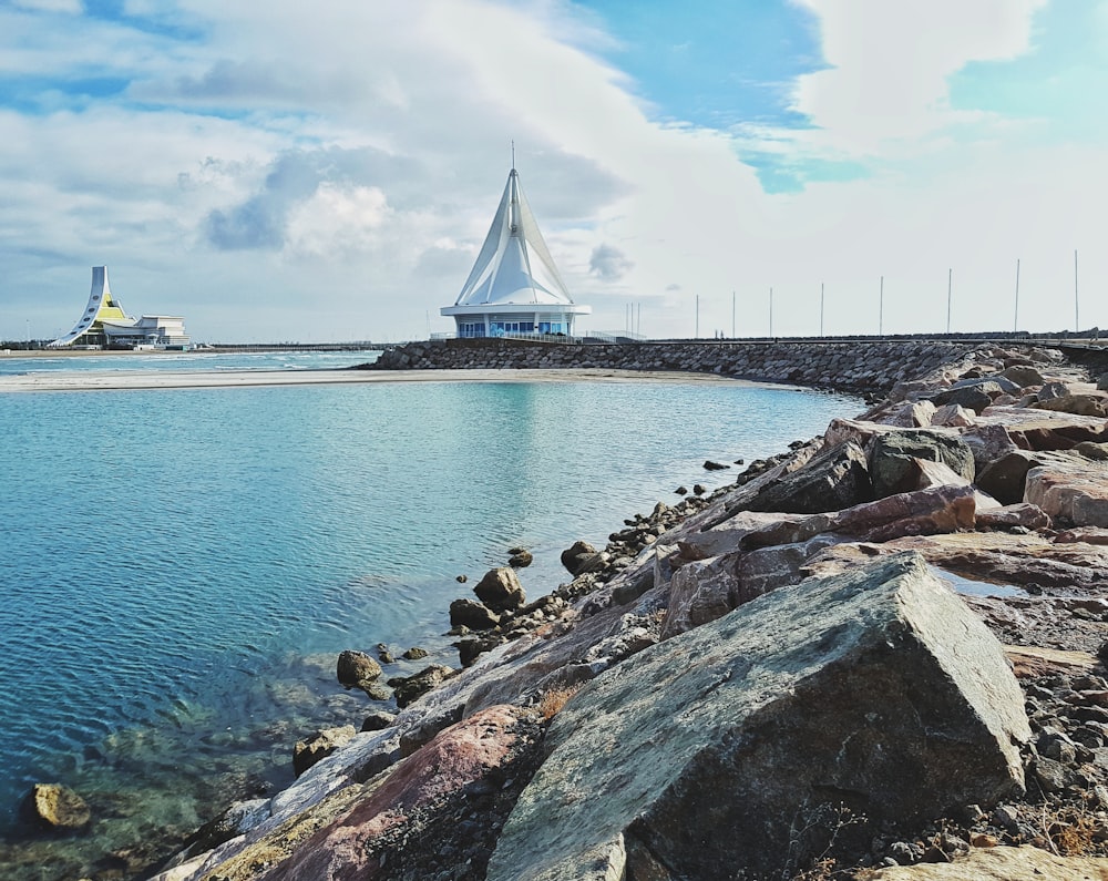 white bridge over the sea during daytime