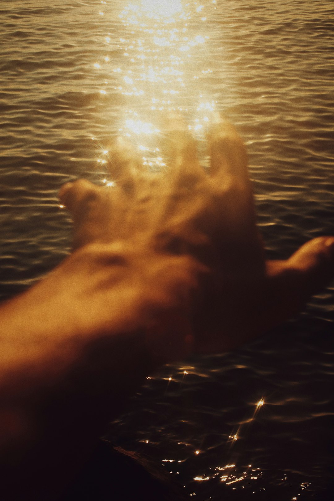 person holding a light in body of water during daytime