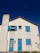 Cozy home in Chiloé with bright white and sky blue PVC windows installed by Brisa Austral.
