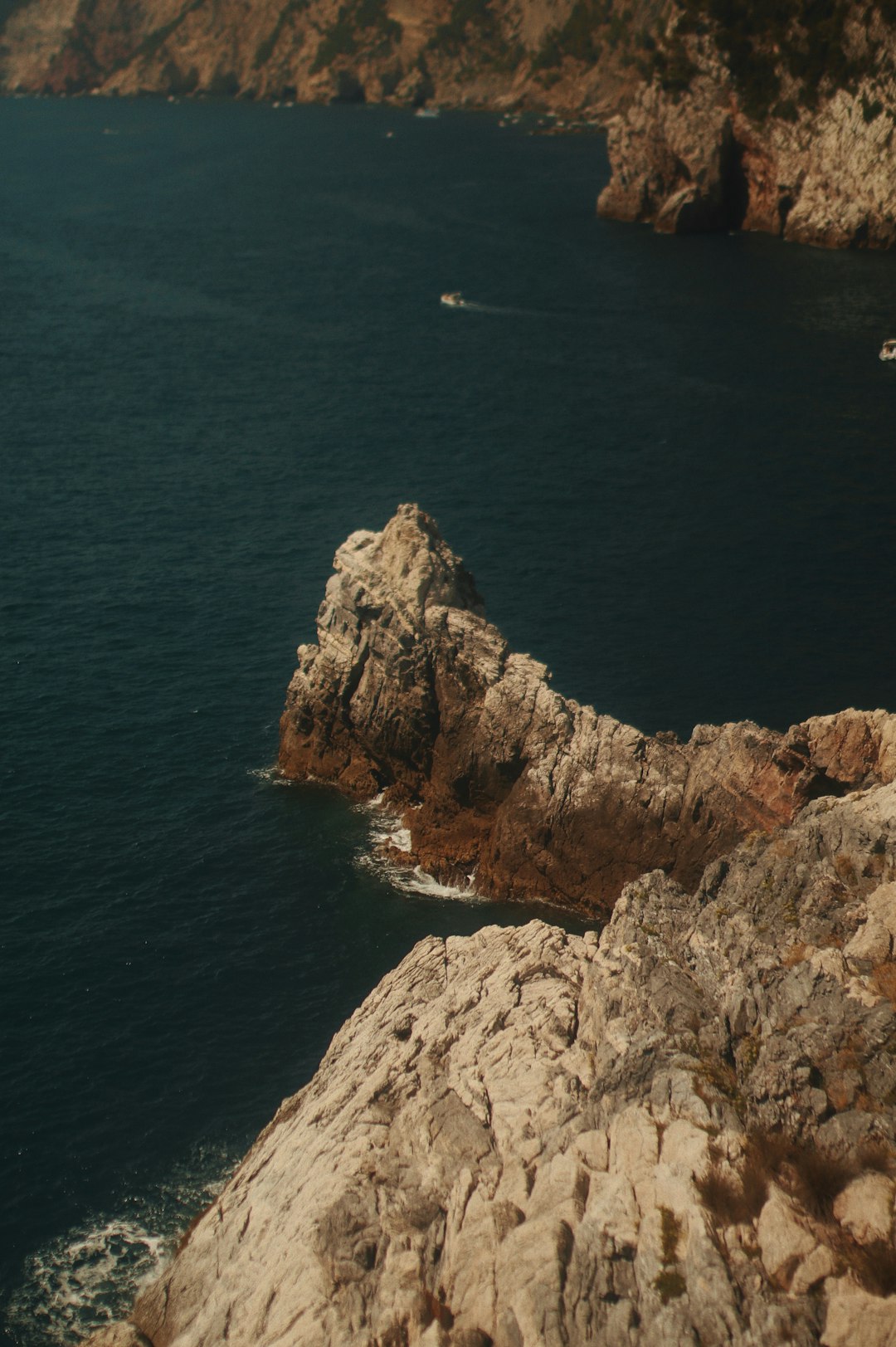 brown rock formation beside body of water during daytime