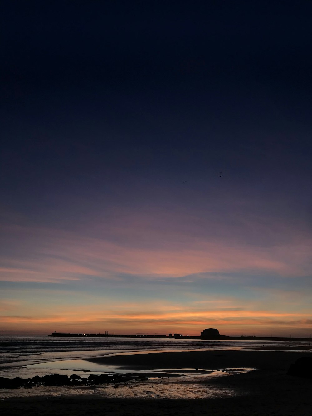 silhouette of people on beach during sunset