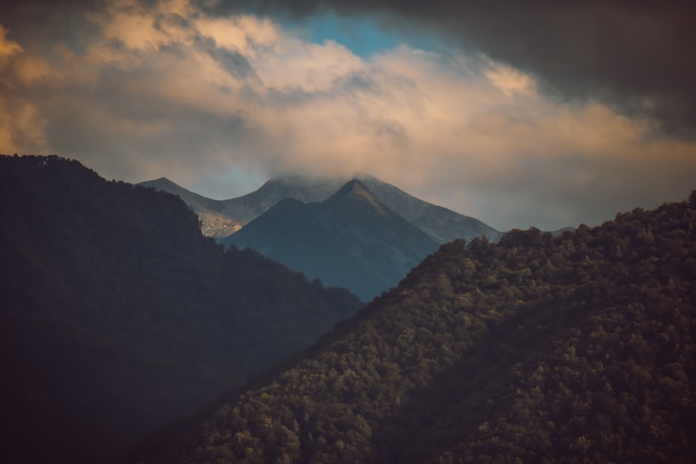 black and white mountain under cloudy sky during daytime