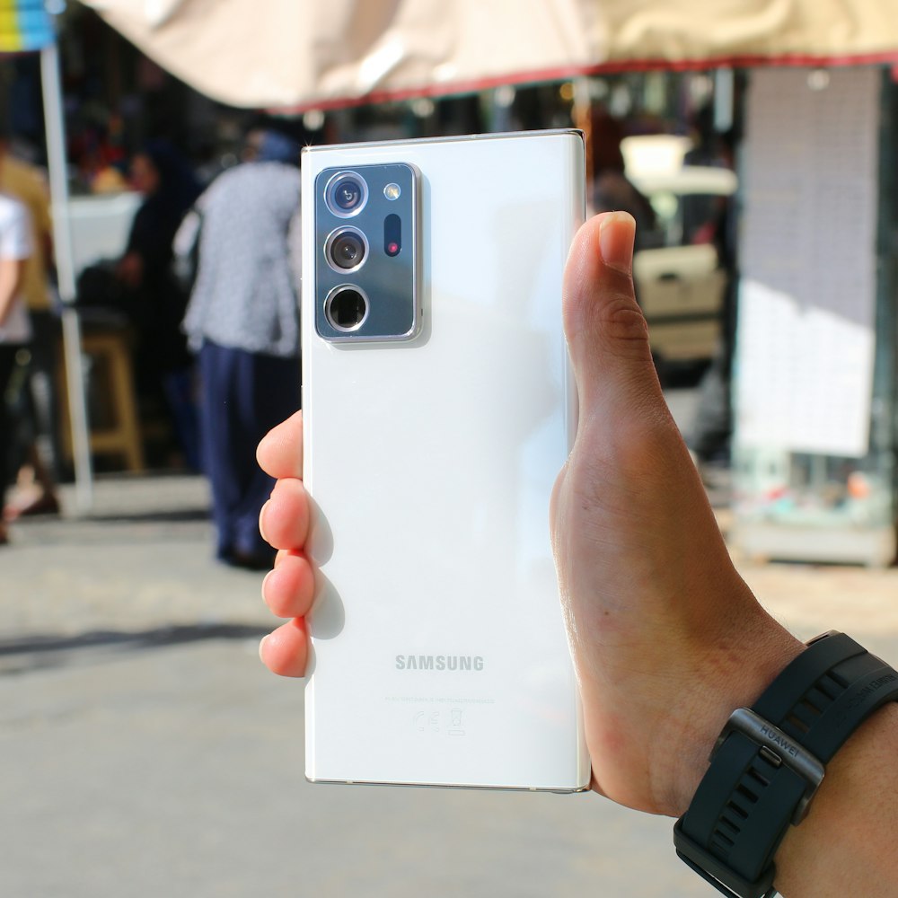 person holding white samsung galaxys 3