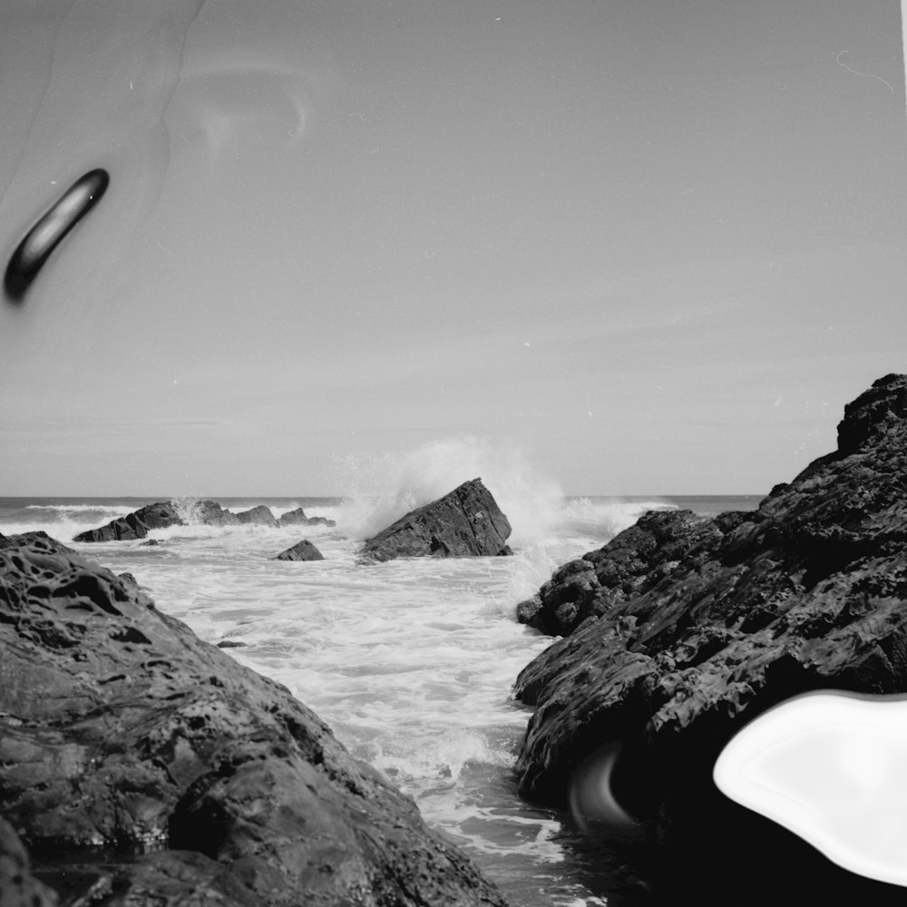 grayscale photo of rocky shore