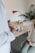 person in white long sleeve shirt holding white textile
