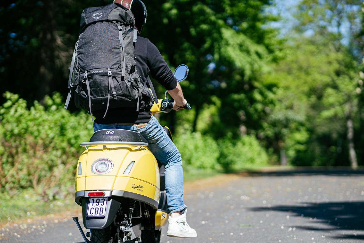 man on motorbike with backpack