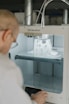 person in white shirt using sewing machine