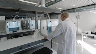 Technician inspecting a plastic part after CNC milling in a modern workshop.