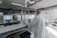 A technician inspecting a large 3D printed component in a modern workshop.