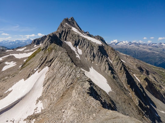 gray and green mountain under blue sky during daytime in Pizzo Gallina Switzerland