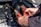 person holding red and black hand tool