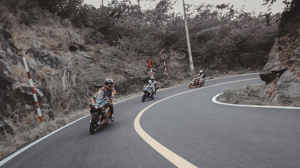 man in red jacket riding motorcycle on road during daytime