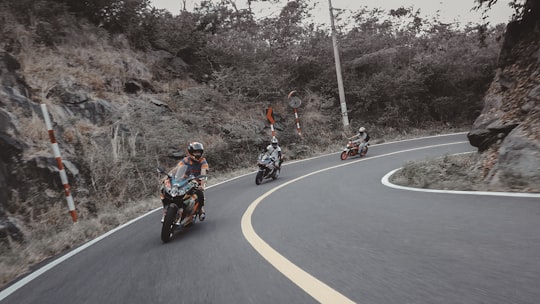 man in red jacket riding motorcycle on road during daytime in Côn Đảo Vietnam