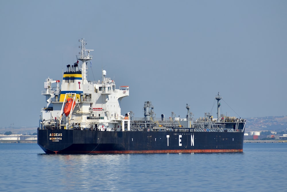 black and white ship on sea under gray sky during daytime