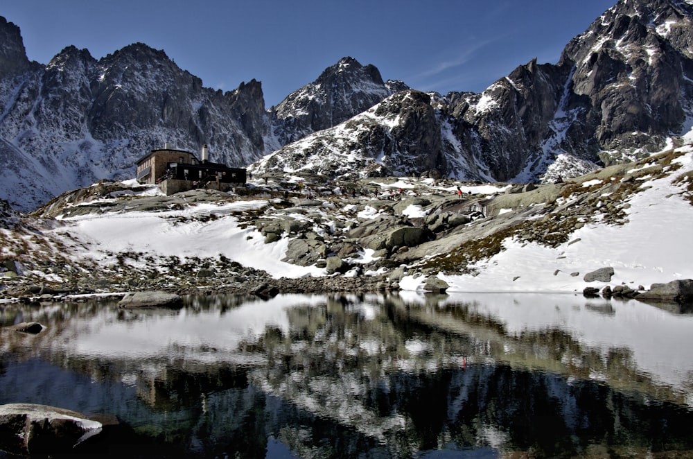 brown house on snow covered mountain during daytime