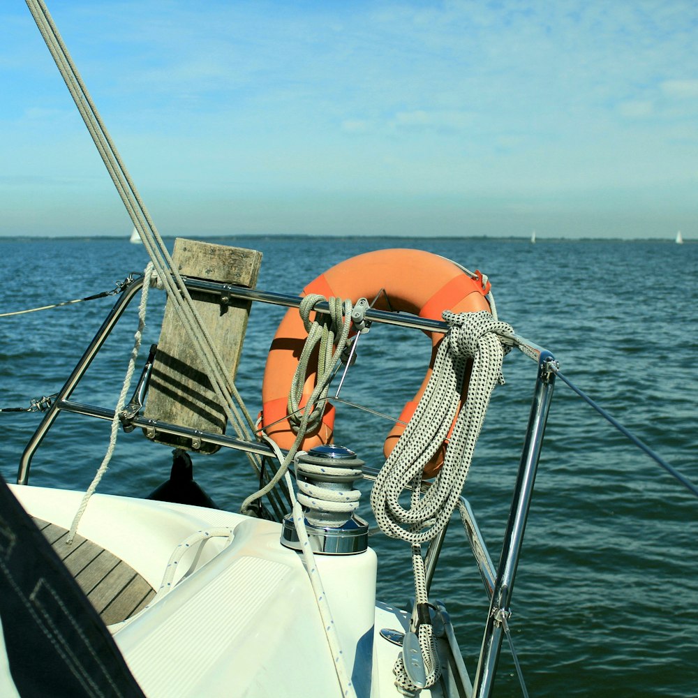 white and orange boat on sea during daytime