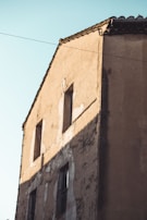 Before and after view of a building transformed by fresh paint in warm tones.