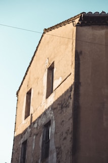 Before and after images showing transformation of an old building after painting