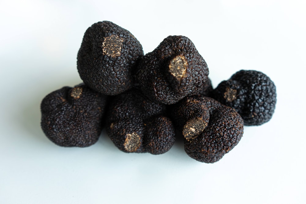 brown round fruit on white surface