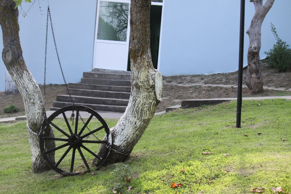 brown wooden wheel on green grass near body of water during daytime