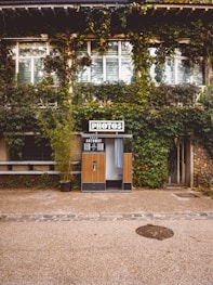 brown wooden door near green trees during daytime