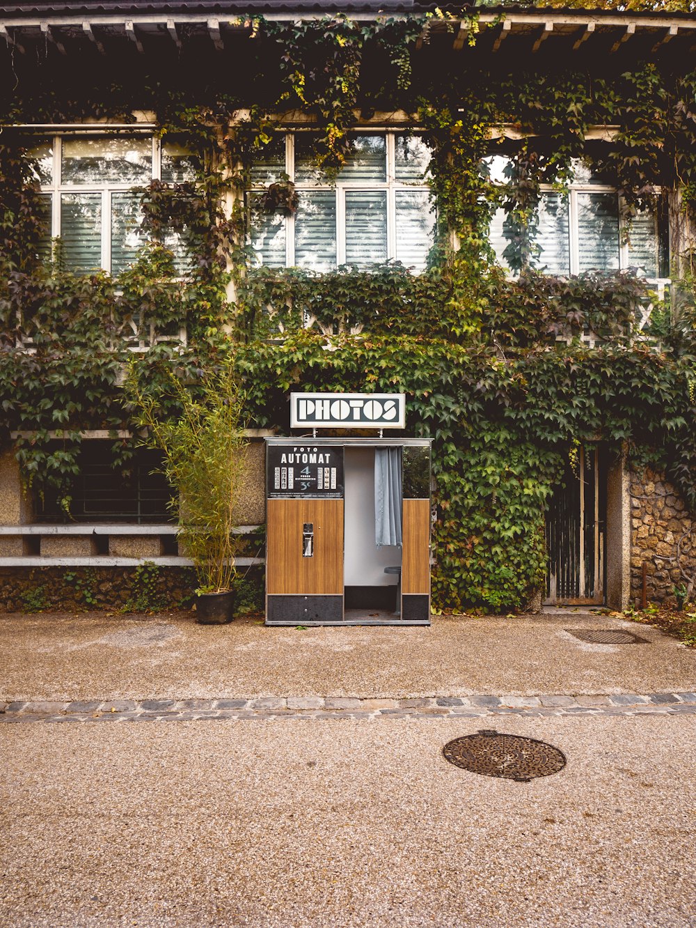 brown wooden door near green trees during daytime