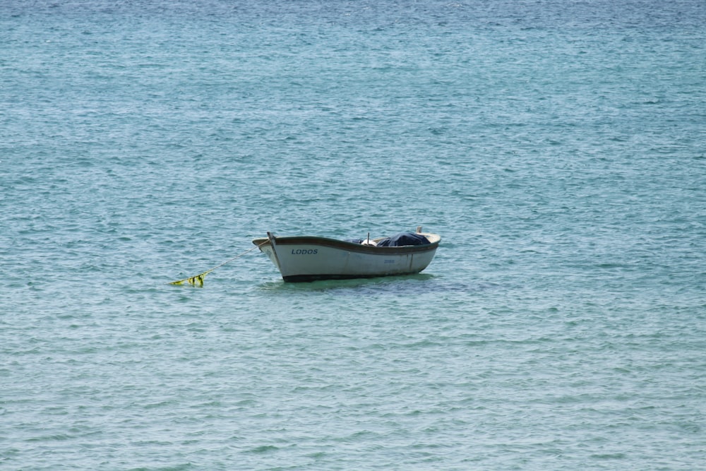 white and yellow boat on sea during daytime