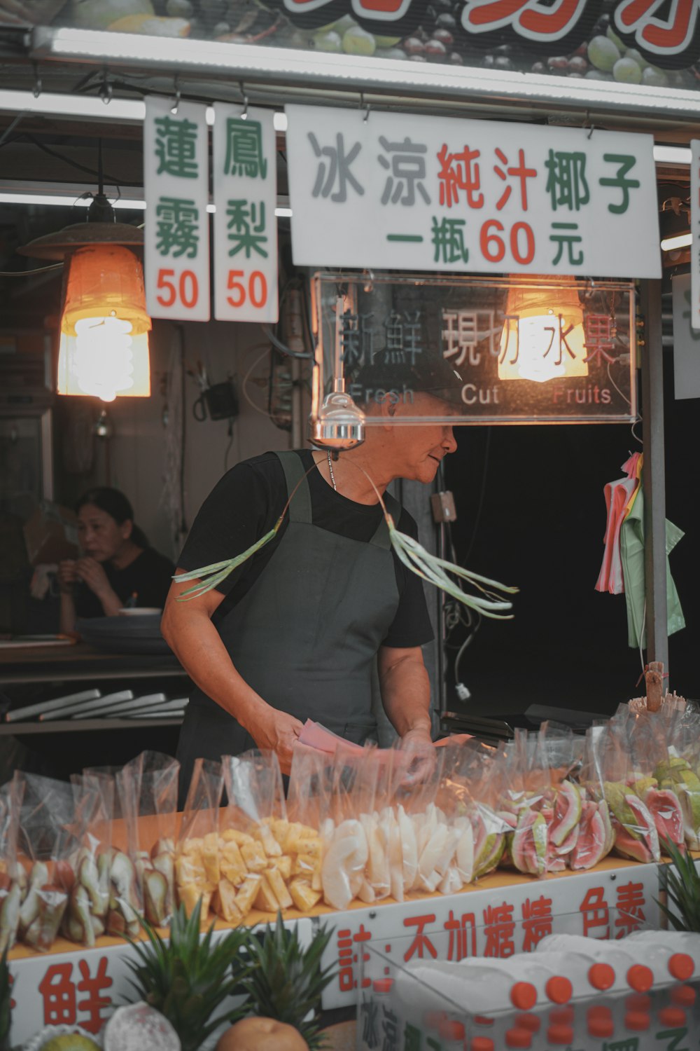 man in black t-shirt and gray denim jeans holding clear plastic bag