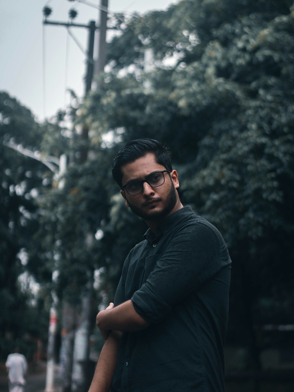 man in black long sleeve shirt wearing black sunglasses