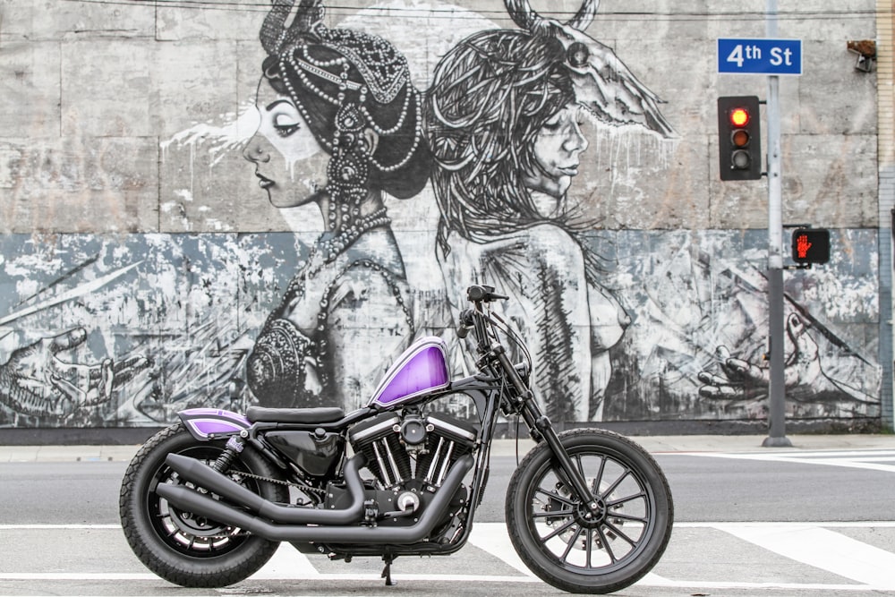 black and purple motorcycle beside womans face graffiti