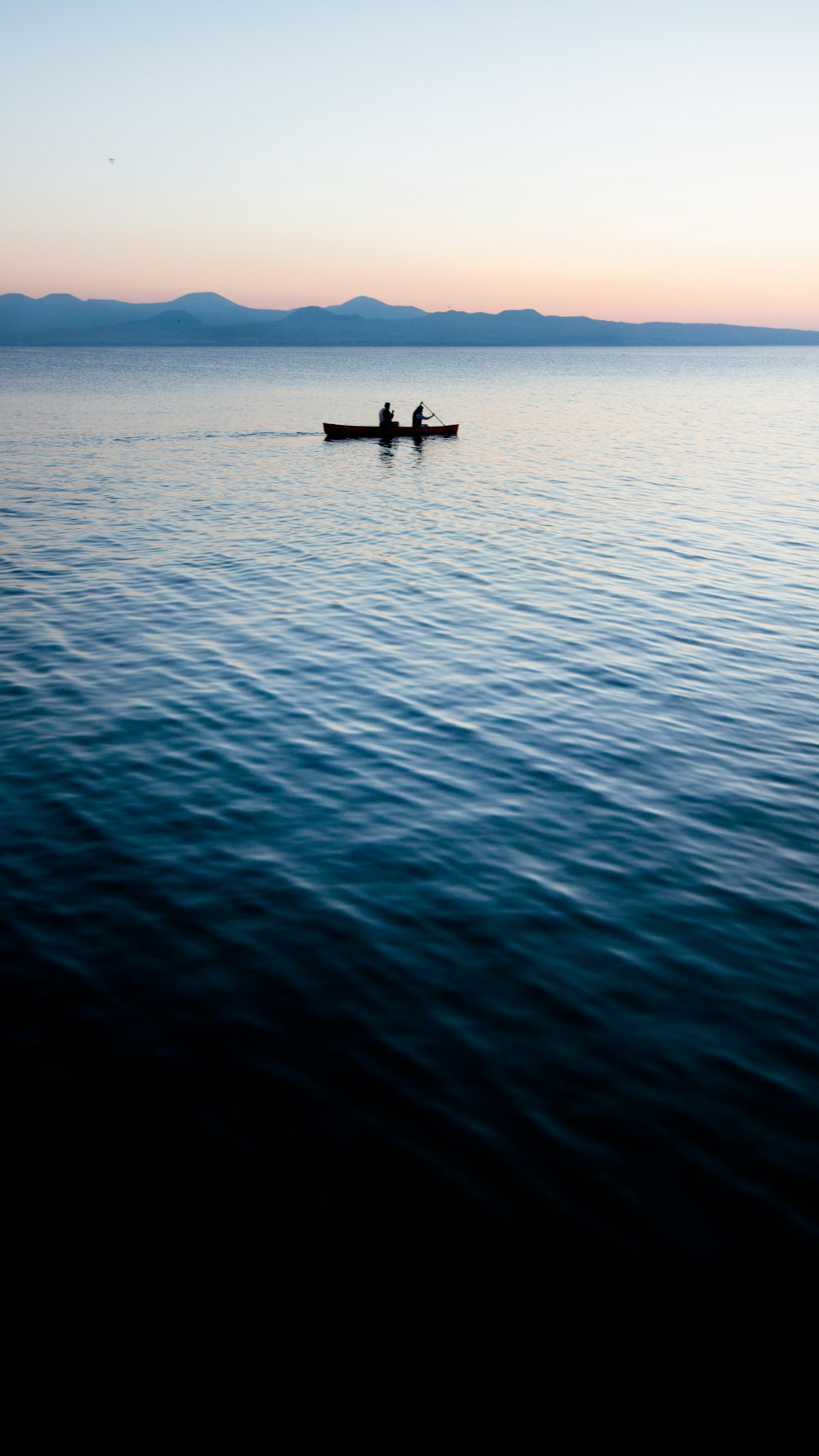 person riding on boat on sea during daytime