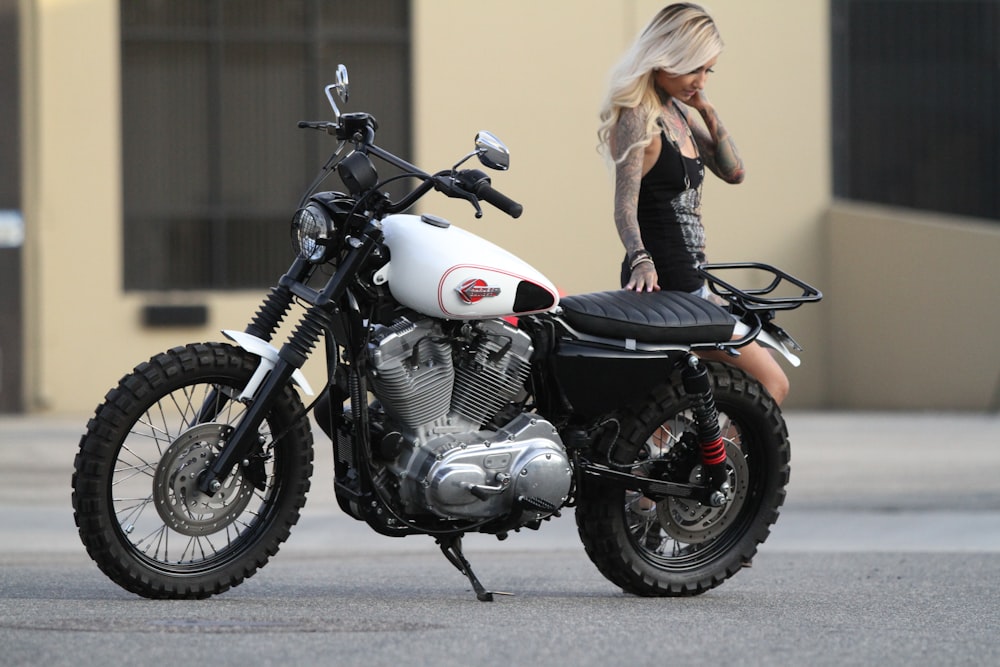 woman in black jacket riding on white and black motorcycle