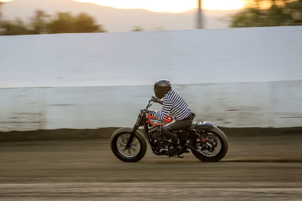 man in white and black jacket riding black motorcycle on gray asphalt road during daytime