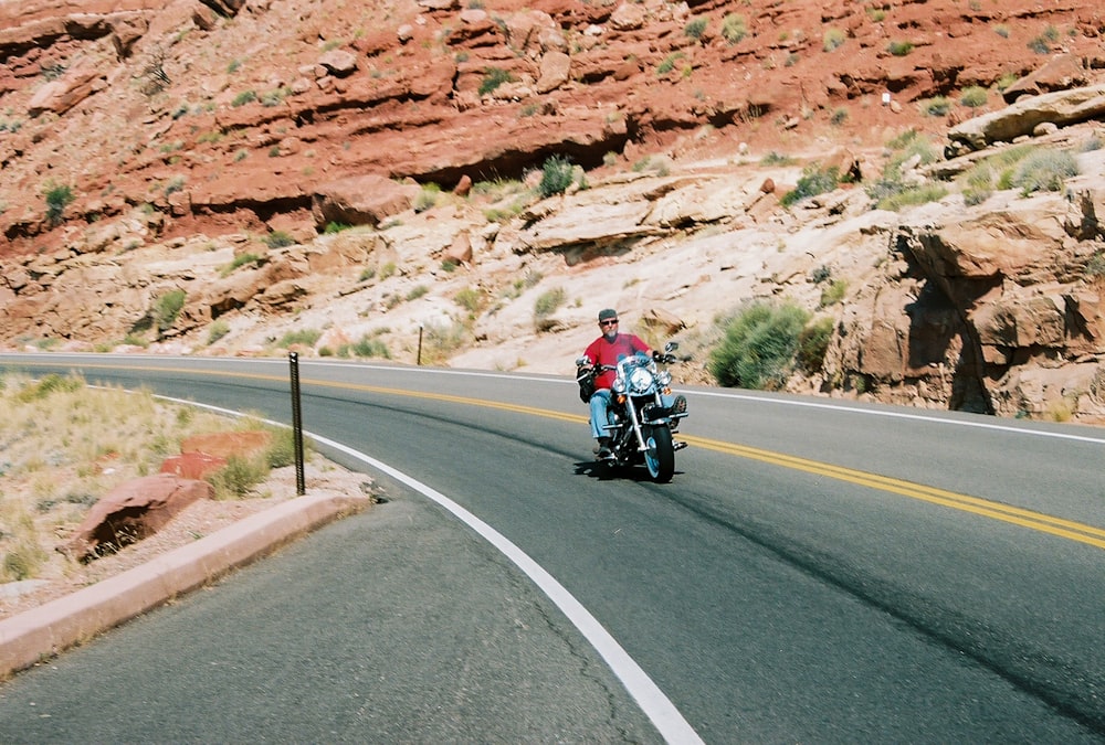 man riding motorcycle on road during daytime