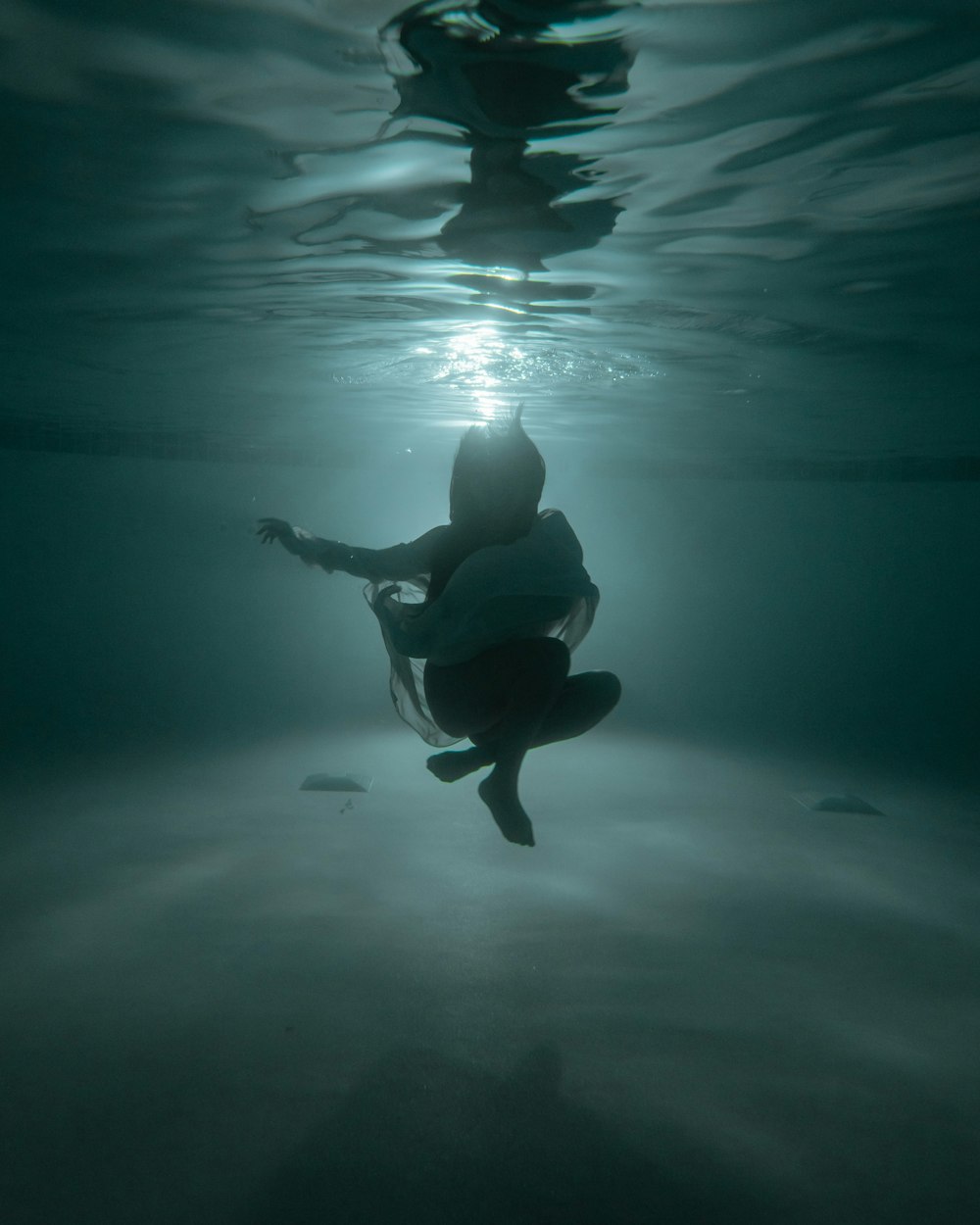 man in black shorts in water