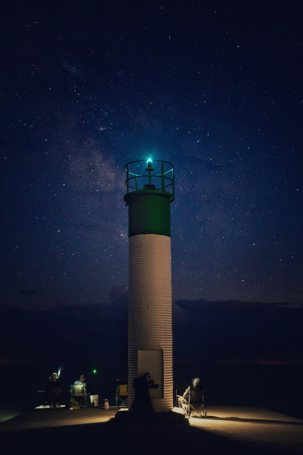 white and black light tower during night time