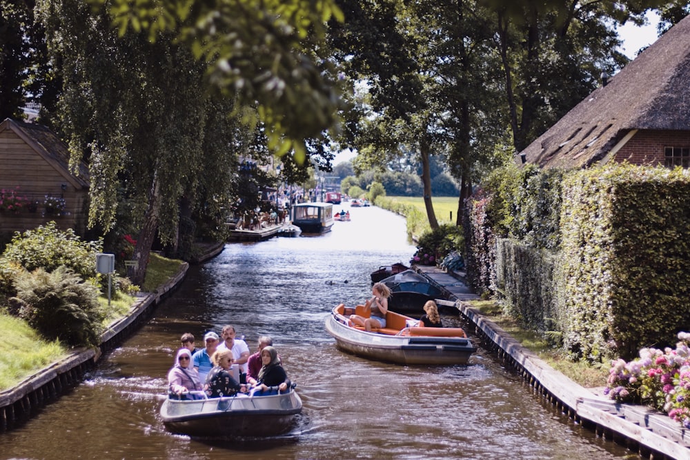 people riding on boat on river during daytime