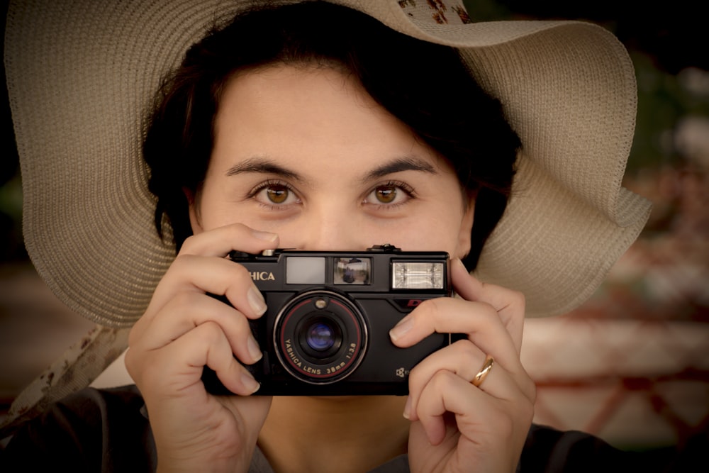 woman holding black and silver camera