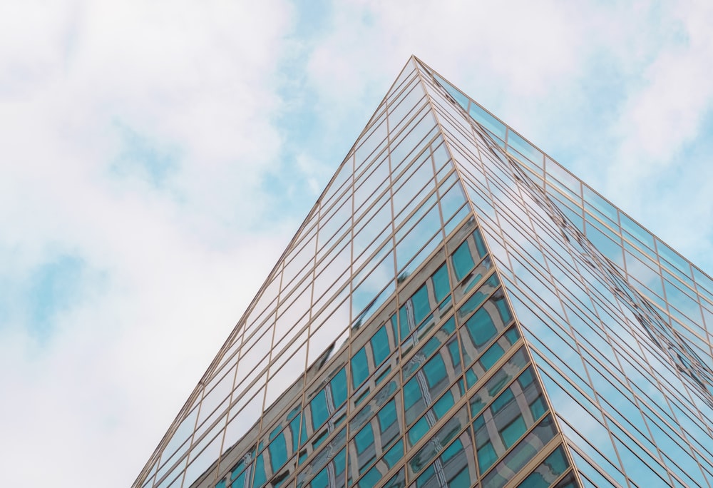 gray concrete building under white clouds during daytime