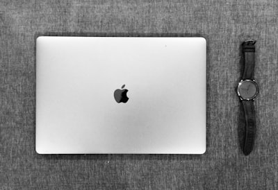 silver macbook on brown textile gray google meet background