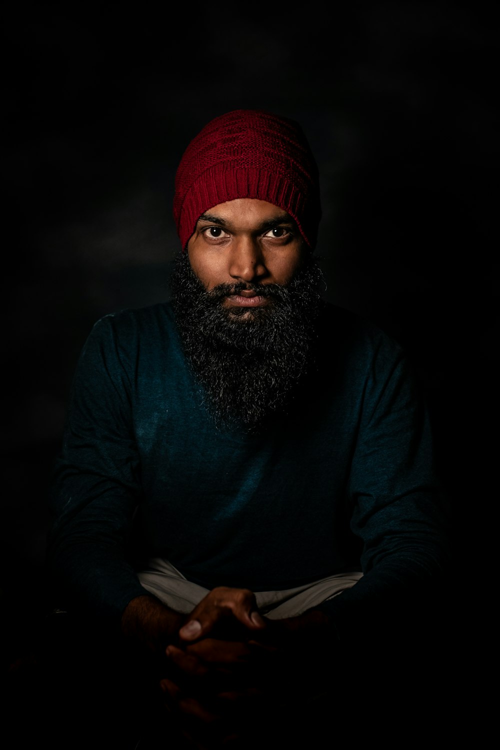 man in blue long sleeve shirt wearing red knit cap