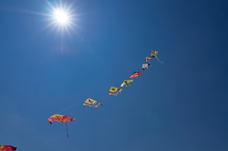 Children releasing colorful kites into a bright blue sky, symbolizing new beginnings.