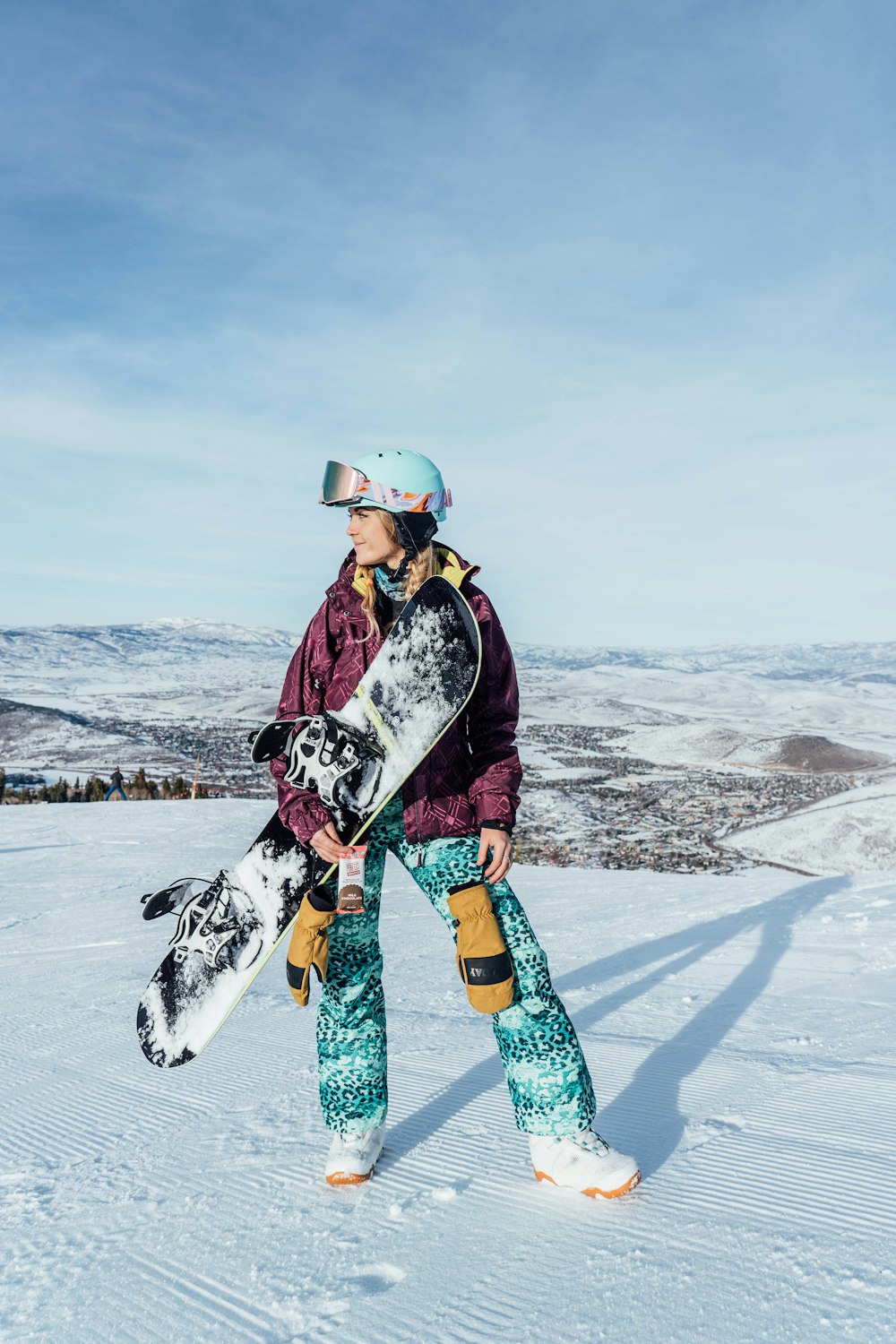woman in black jacket and blue pants with white and black dalmatian dog on snow covered