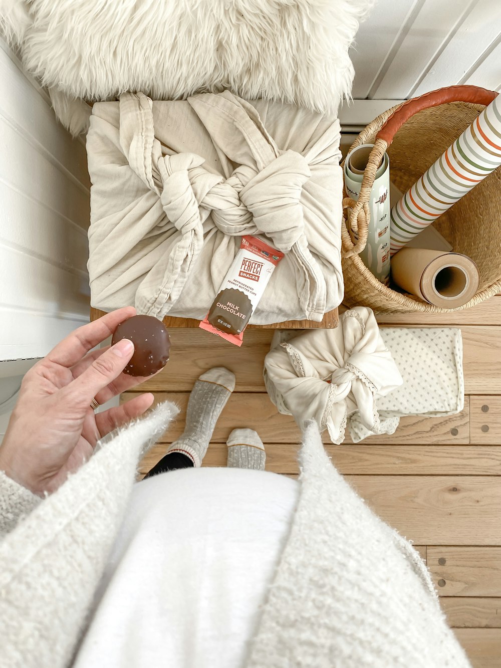 person in white jacket holding brown wooden rolling pin