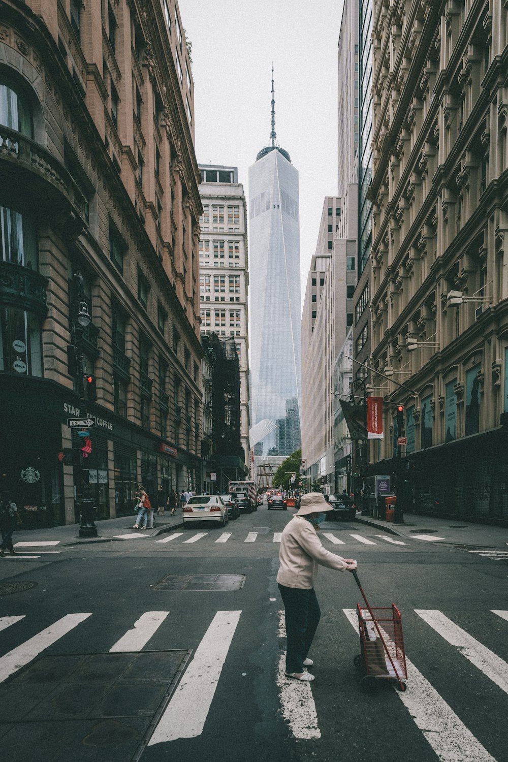 a person pushing a cart down a city street