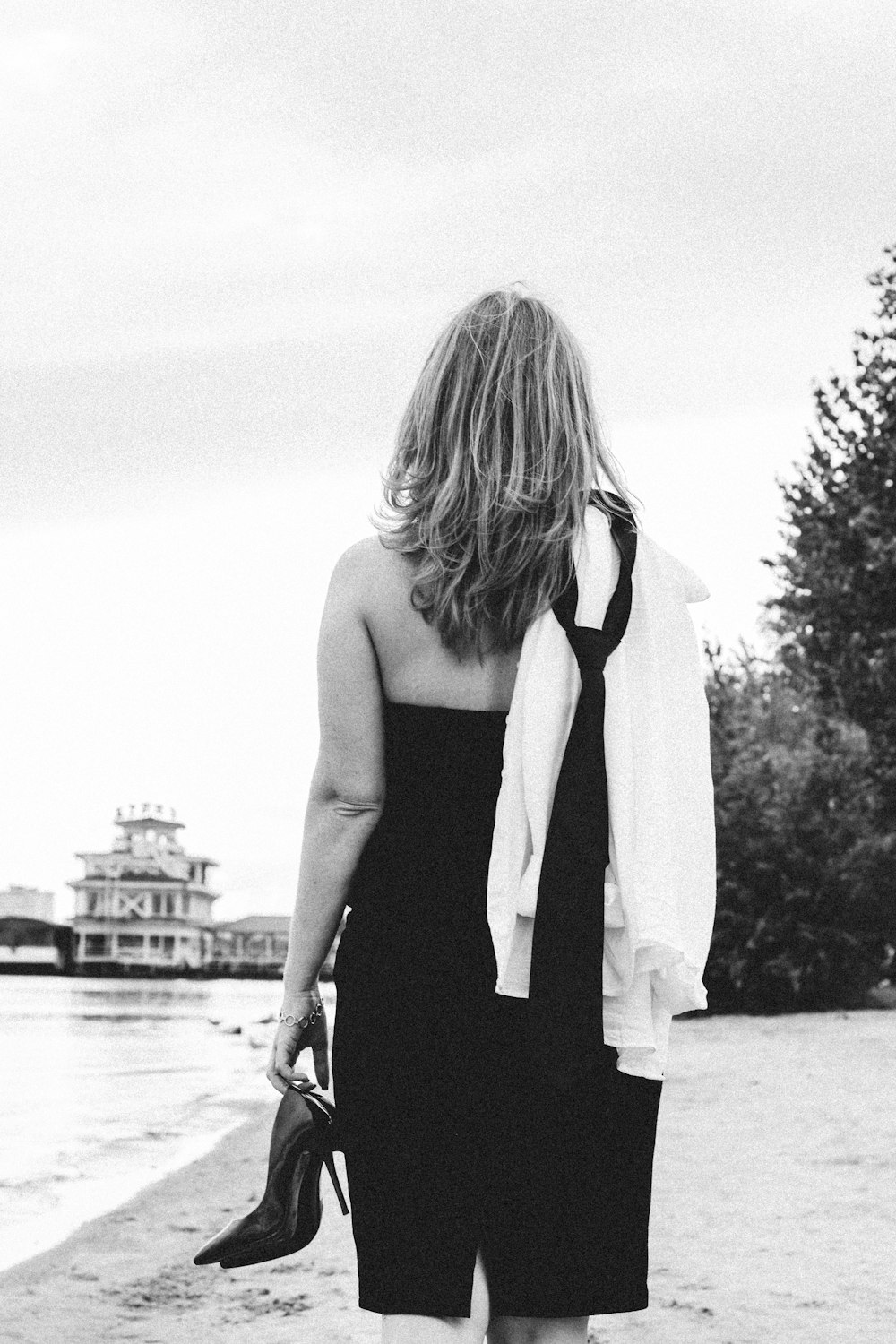 woman in black tank top standing on the beach