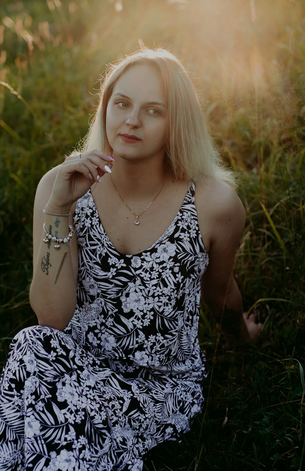 woman in black and white floral spaghetti strap dress