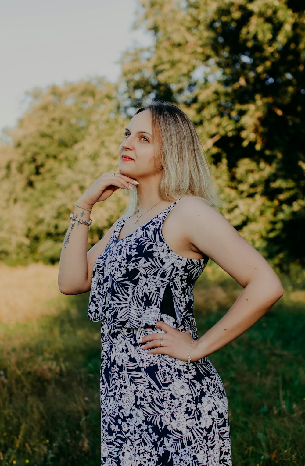 woman in black and white floral spaghetti strap dress